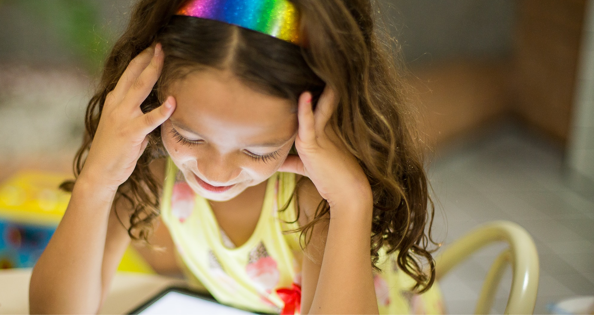 small child happily looking at tablet screen 