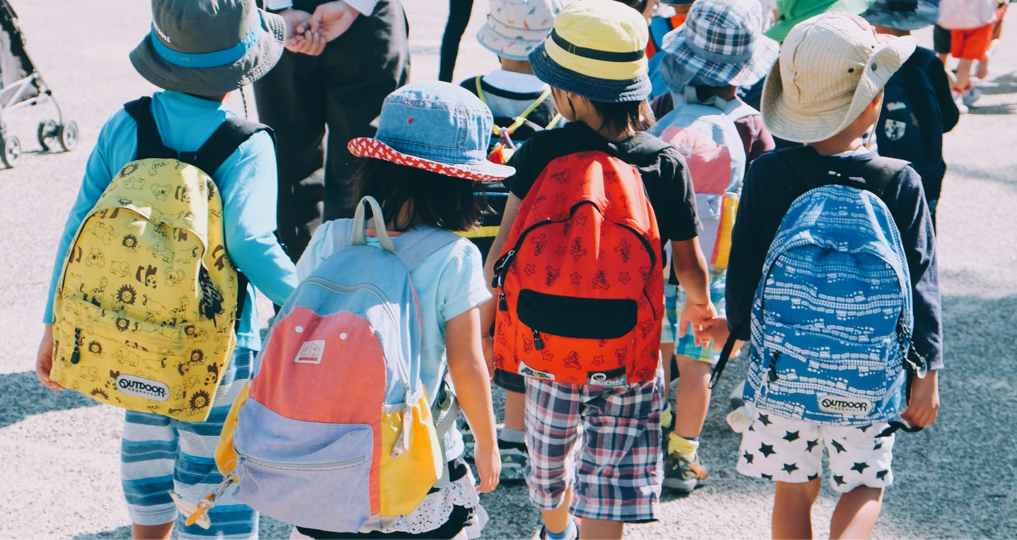 children wearing backpacks